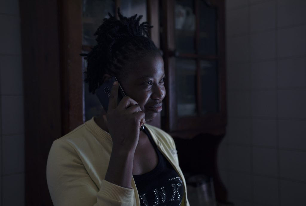 Sierra Leonean domestic worker calling relatives, after her phone was confiscated for months.