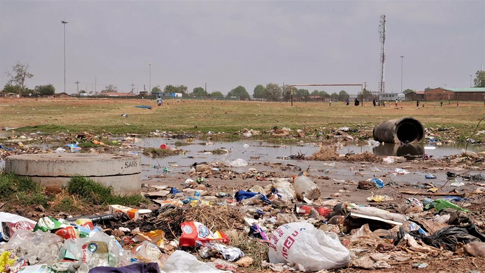 A growing illegal dumpsite on a local community grounds in Huruma Eldoret, consisting of plastic water bottles, orange peels and plastic bags.