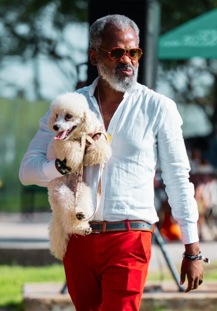 STATUS – A gentleman leisurely strolls with his poodle by his side as he attends a weekend event in upmarket Nairobi.